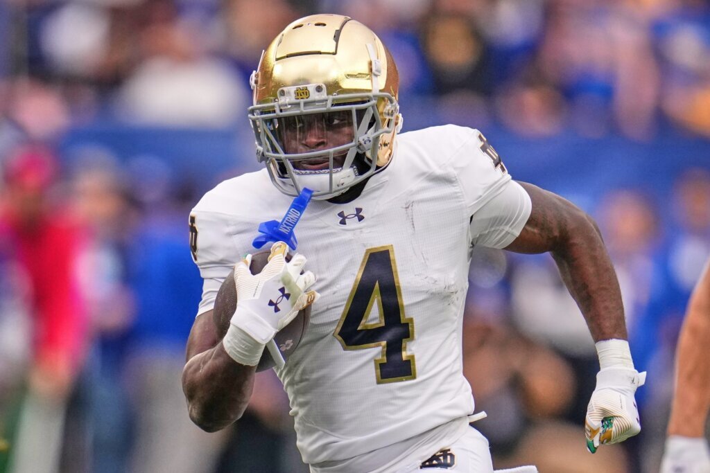 FILE - Notre Dame running back Jeremiyah Love (4) carries the ball during the first half of an NCAA college football game against Pittsburgh in Pittsburgh Saturday, Nov. 15, 2025. (AP Photo/Gene J. Puskar, File)