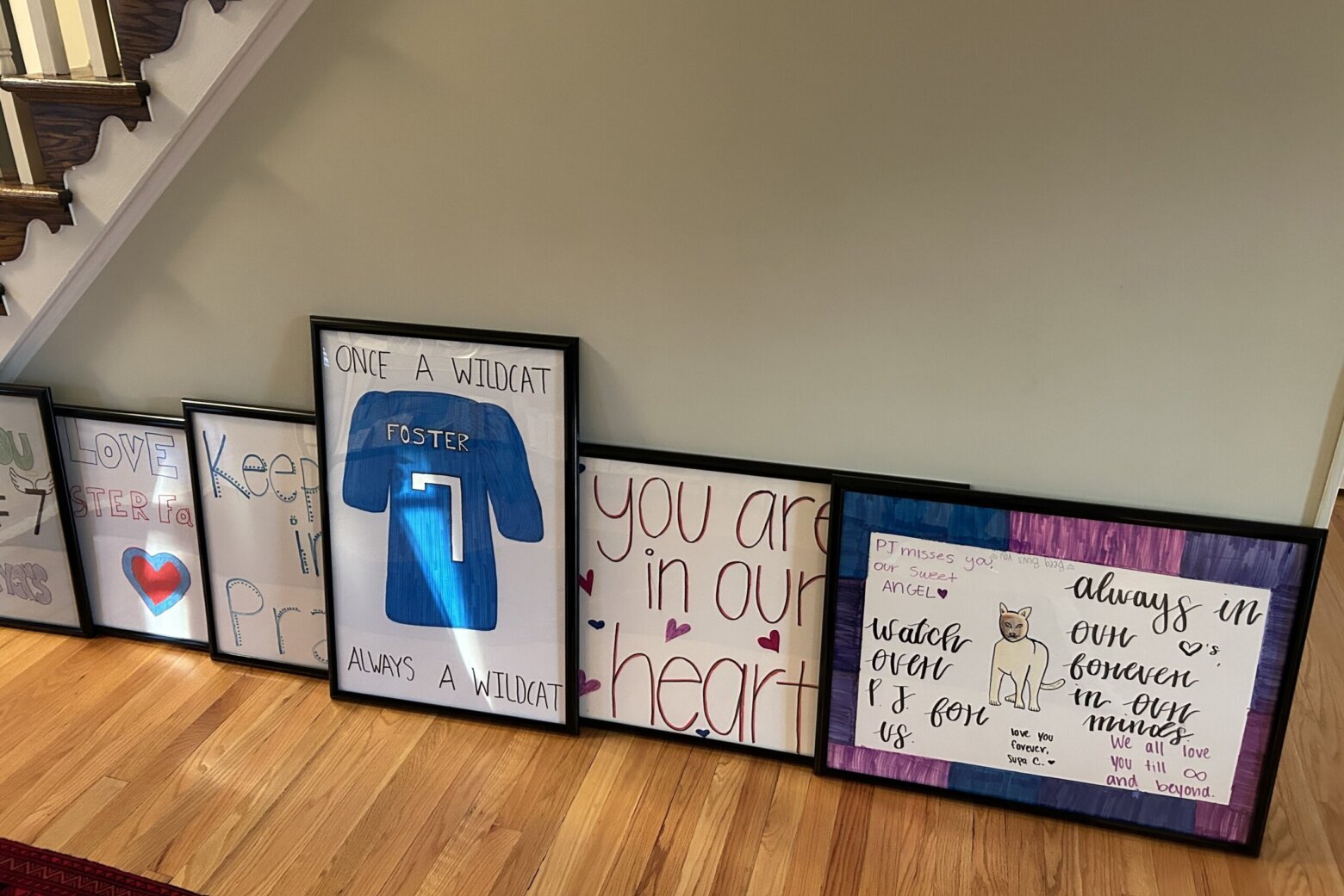 framed pictures and posters and note line hallway floor in home