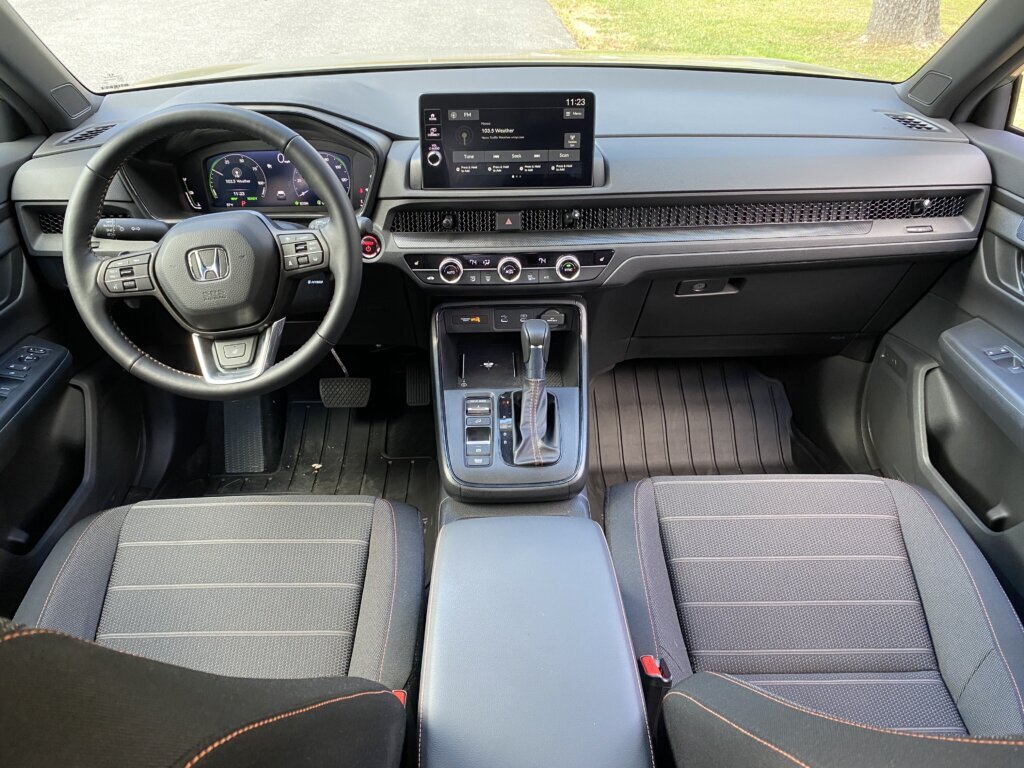 Inside, the TrailSport Hybrid keeps things simple. It has a straightforward interior, featuring black cloth seats with orange stitching and the TrailSport logo embroidered on the headrests.