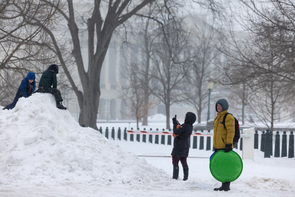 WASHINGTON, DC - JANUARY 25: Children play in the snow near the US Capitol on January 25, 2026 in Washington, DC. A massive winter storm is expected to bring frigid temperatures, ice, and snow to millions of Americans across the nation. (Photo by Anna Rose Layden/Getty Images)