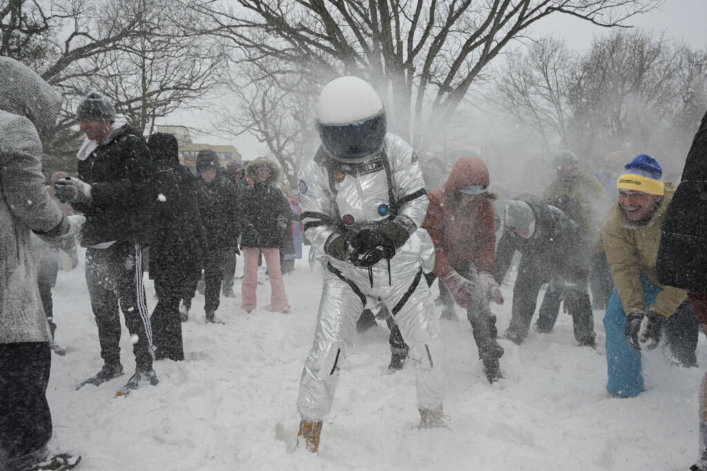 People participate in a snowball fight in Meridian Hill Park in Washington, DC, on January 25, 2026. A massive winter storm on January 24 dumped snow and freezing rain from New Mexico to North Carolina as it swept across the United States towards the northeast, threatening tens of millions of Americans with blackouts, transportation chaos and bone-chilling cold. After battering the country's southwest and central areas, the storm system began to hit the heavily populated mid-Atlantic and northeastern states as a frigid air mass settled in across the nation. (Photo by Oliver Contreras/AFP via Getty Images)