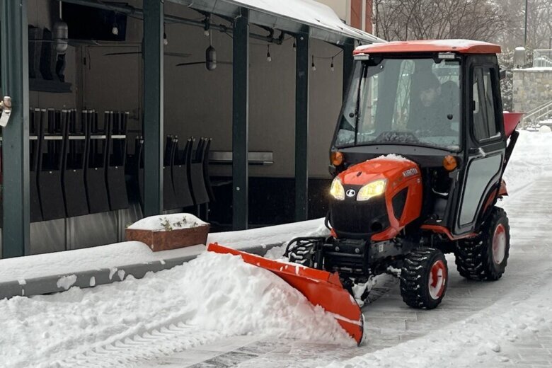 A small plow clears the area in front of a story in Chevy Chase, Maryland, on Sunday, Jan. 25, 2026. (WTOP/Julia Ziegler)