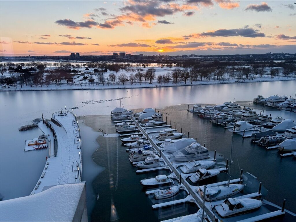 The sun sets over the Wharf in the District from the roof of Whiskey Charlie's. (WTOP/Alan Etter)