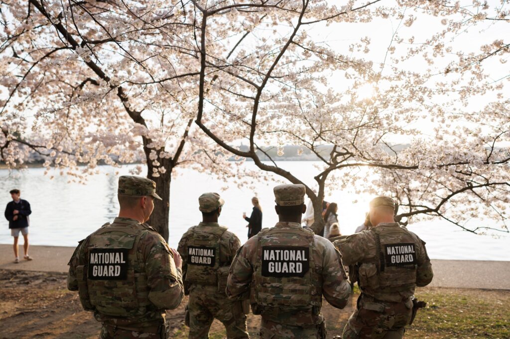 Members of the Mississippi National Guard patrol among the cherry blossom trees along the tidal basin on the National Mall on Thursday, March 26, 2026, in Washington. (AP Photo/Tom Brenner)