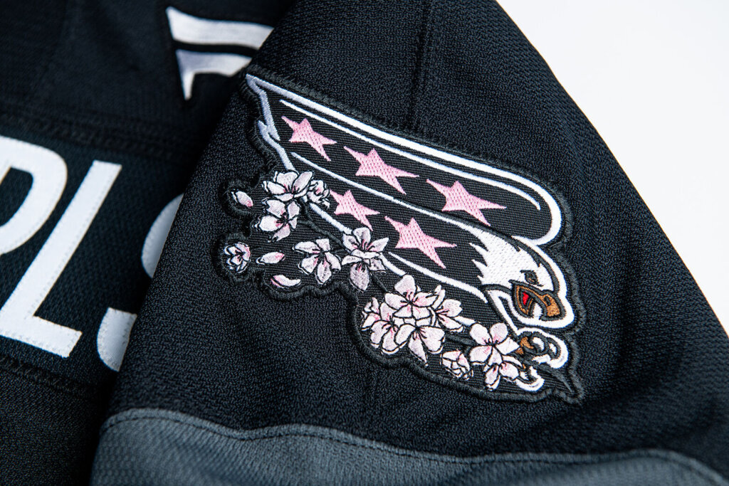 The team’s eagle logo appears on the shoulder with a branch of cherry blossoms on its talons.