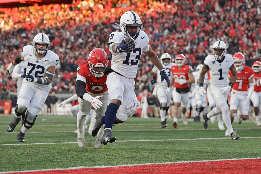 Penn State running back Kaytron Allen (13) scores a touchdown past Rutgers linebacker Dariel Djabome (8) during the first half of an NCAA college football game Saturday, Nov. 29, 2025, in Piscataway, N.J. (AP Photo/Adam Hunger)