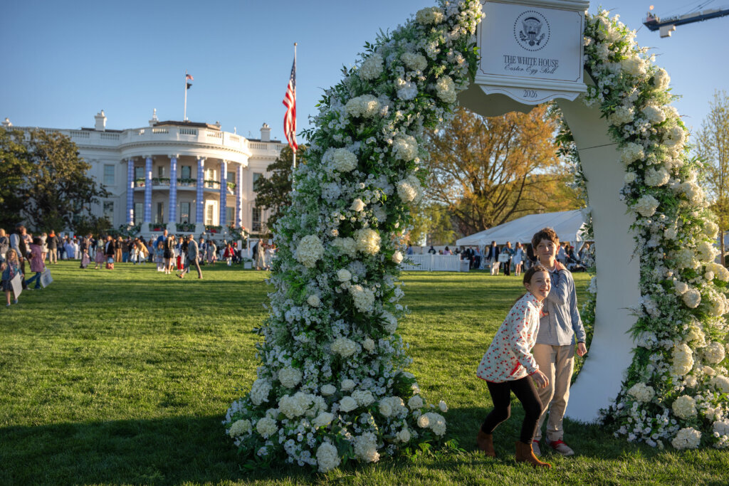 Children walk through a floral arch during the White House Easter Egg Roll on the South Lawn of the White House, Monday, April 6, 2026, in D.C. (AP Photo/Mark Schiefelbein)