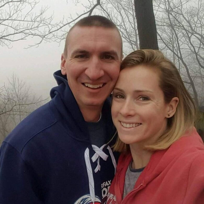 a man and a woman smile for a photo