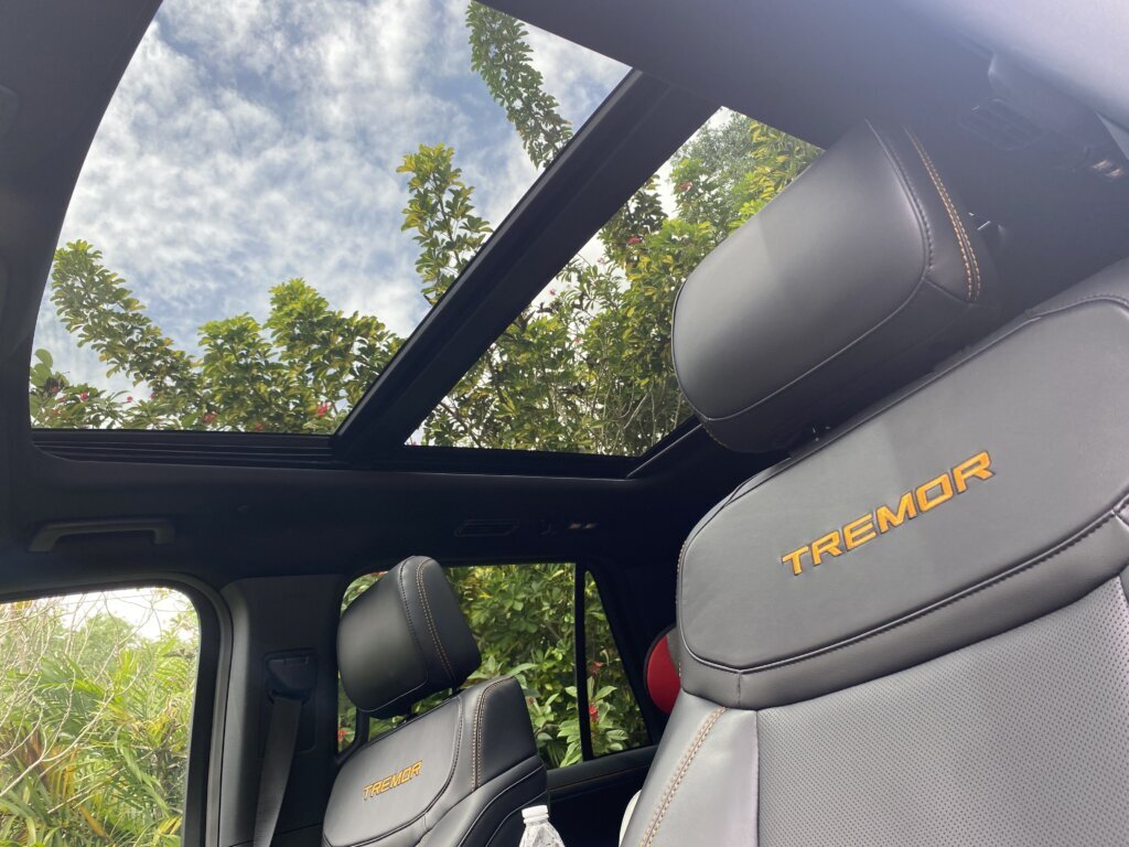 The heated and ventilated, leather-trimmed front seats with “TREMOR” stitched into the front headrests in orange inside the Ford Expedition Tremor.