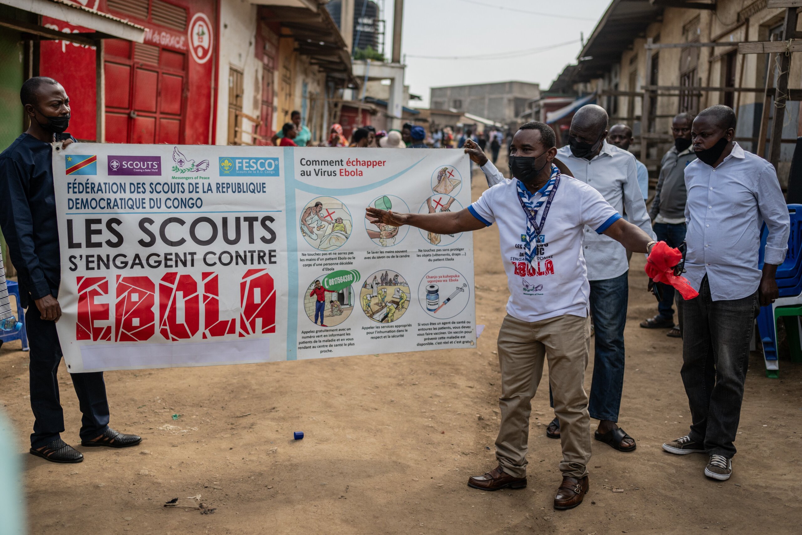 Members of the Congo Scouts movement carry an Ebola awareness banner