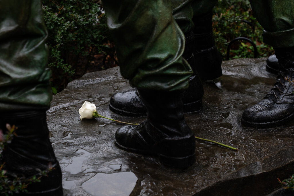 A white rose is placed at the feet of a statue at the Vietnam Veterans Memorial on Memorial Day, Monday, May 25, 2026, in D.C. (AP Photo/Allison Robbert)