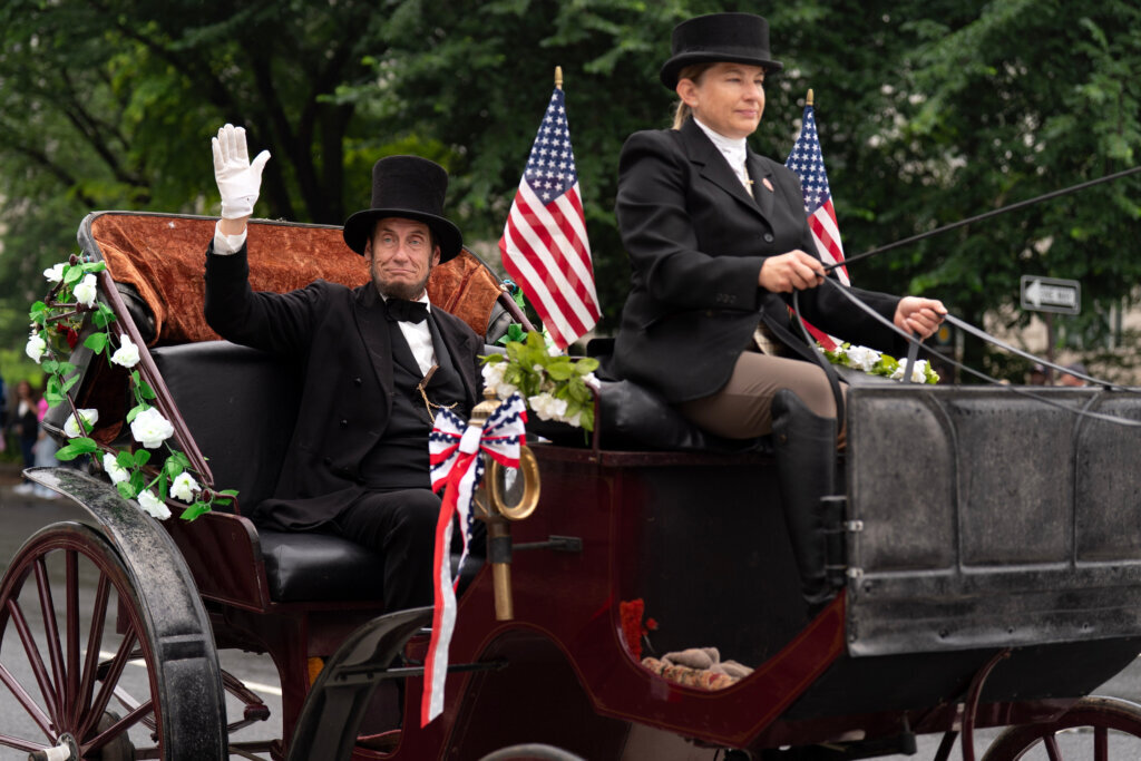 A participant dressed as Abraham Lincoln parades in Washington to commemorate Memorial Day, Monday, May 25, 2026, coinciding with the nation's 250th anniversary celebrations. (AP Photo/Jose Luis Magana)