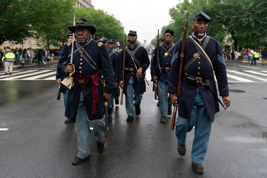Participants dressed in Civil War Union Army uniforms march during a parade in Washington to commemorate Memorial Day, Monday, May 25, 2026, coinciding with the nation's 250th anniversary celebrations. (AP Photo/Jose Luis Magana)