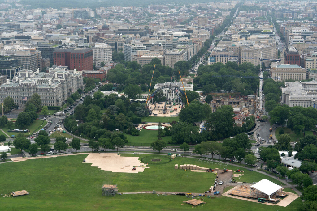 Equipment for a future UFC fight is being placed on the South Lawn in front of the White House, Tuesday, May 26, 2026, in Washington, as work continues on the construction of the ballroom, right, as seen from the Washington Monument. (AP Photo/Mark Schiefelbein)