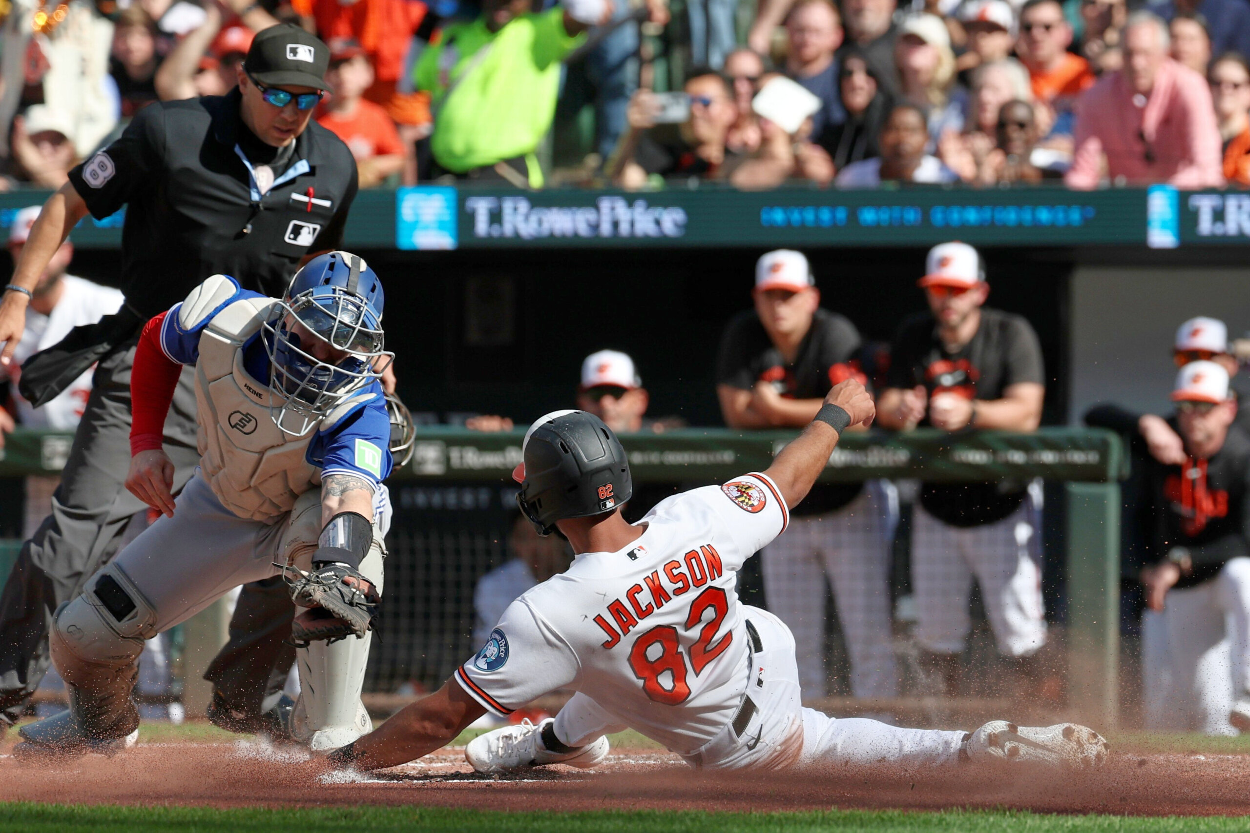 Baltimore Orioles' Jeremiah Jackson (82) avoids the tag by Toronto Blue Jays catcher Tyler Heineman and scores on a single