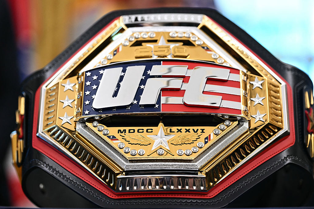 A UFC championship belt is displayed as U.S. President Donald Trump speaks about the upcoming "UFC Freedom 250" event, in the Oval Office of the White House on May 6, 2026, in D.C. (Photo by Kent NISHIMURA / AFP via Getty Images)