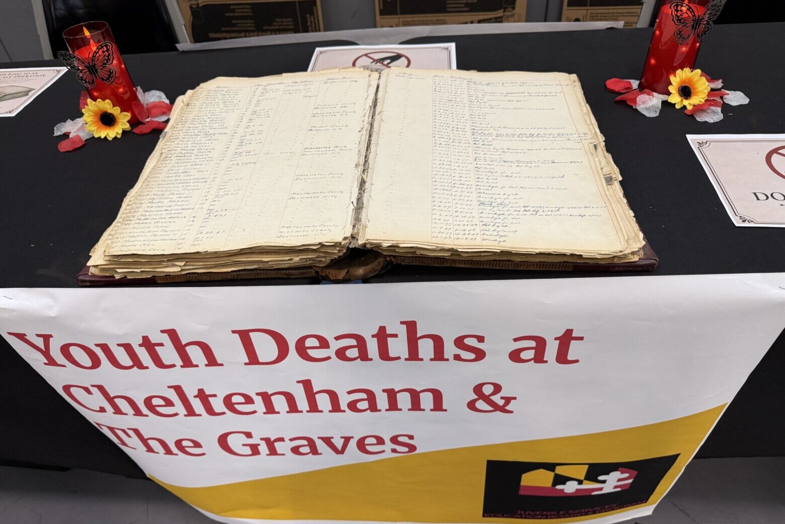 old book on table with sign underneath